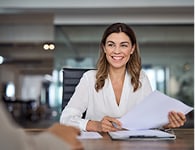 Woman reviewing documents in office.