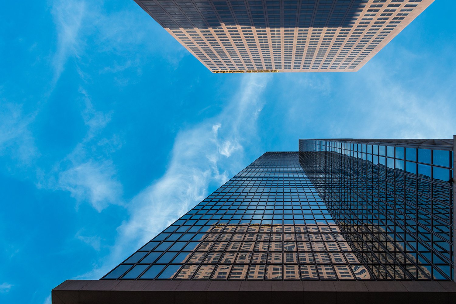 Skyscrapers reaching towards blue sky