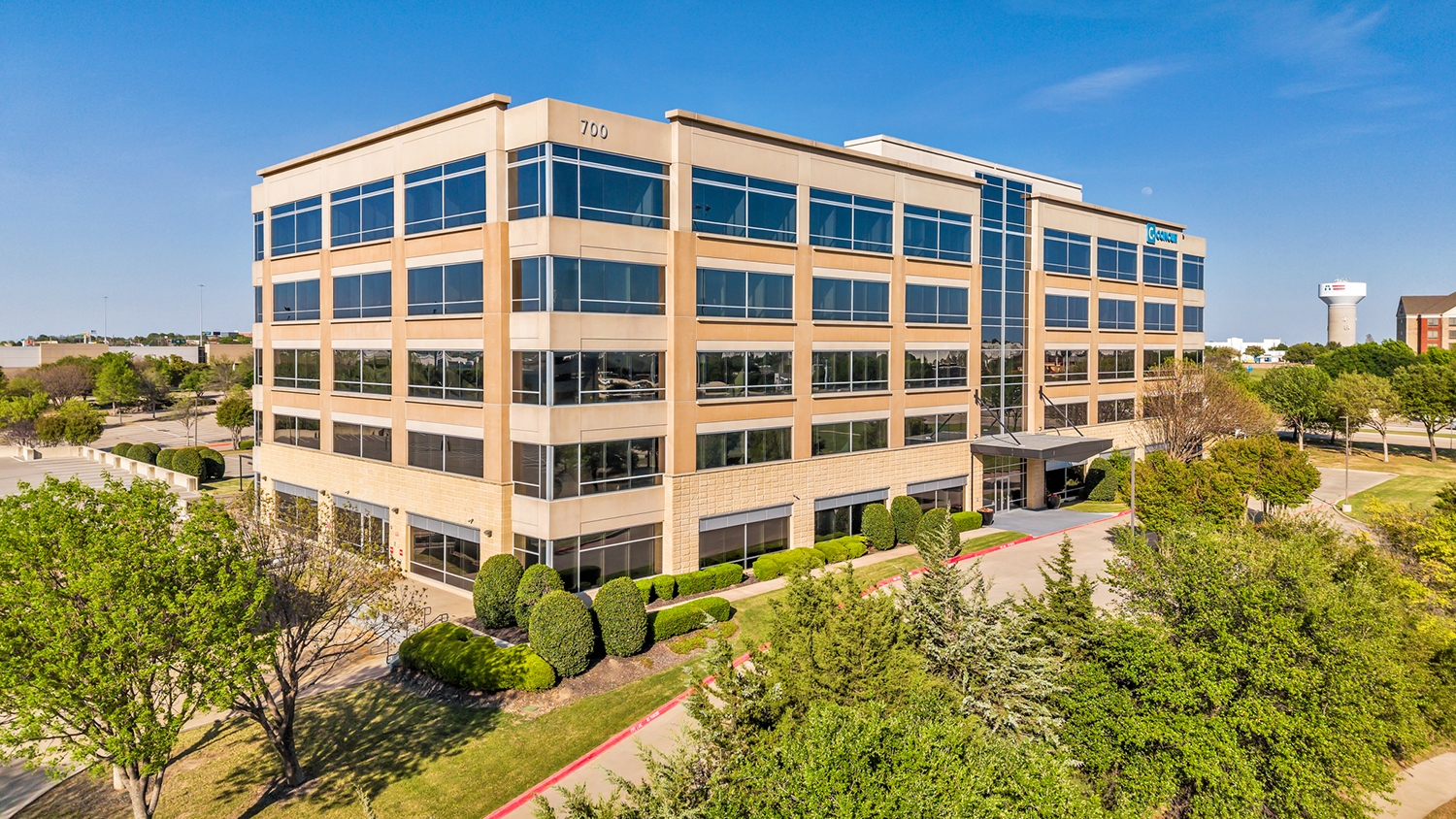 Building from aerial view with trees surrounding the property