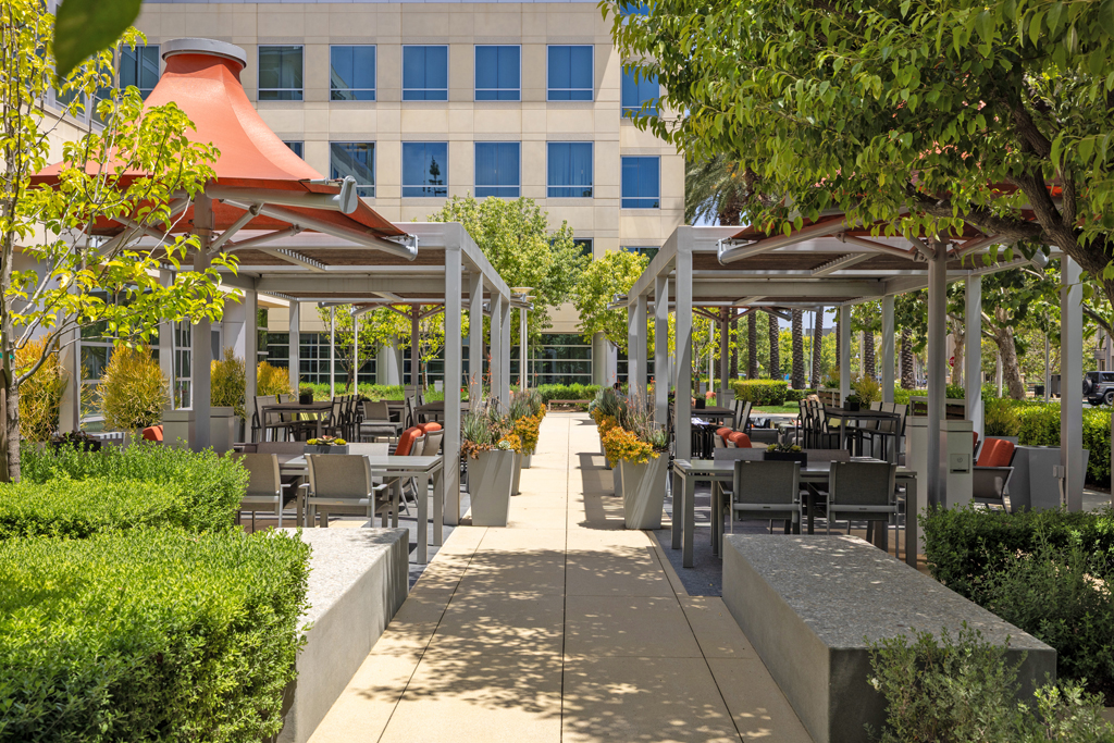 Modern outdoor dining area with greenery