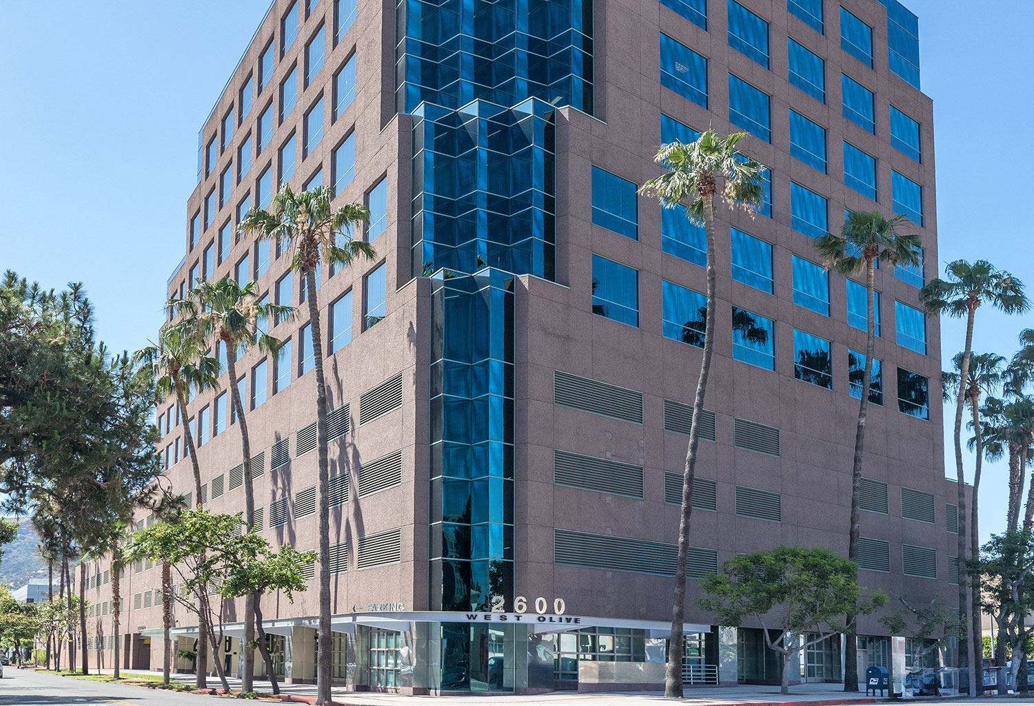 Modern office building with palm trees
