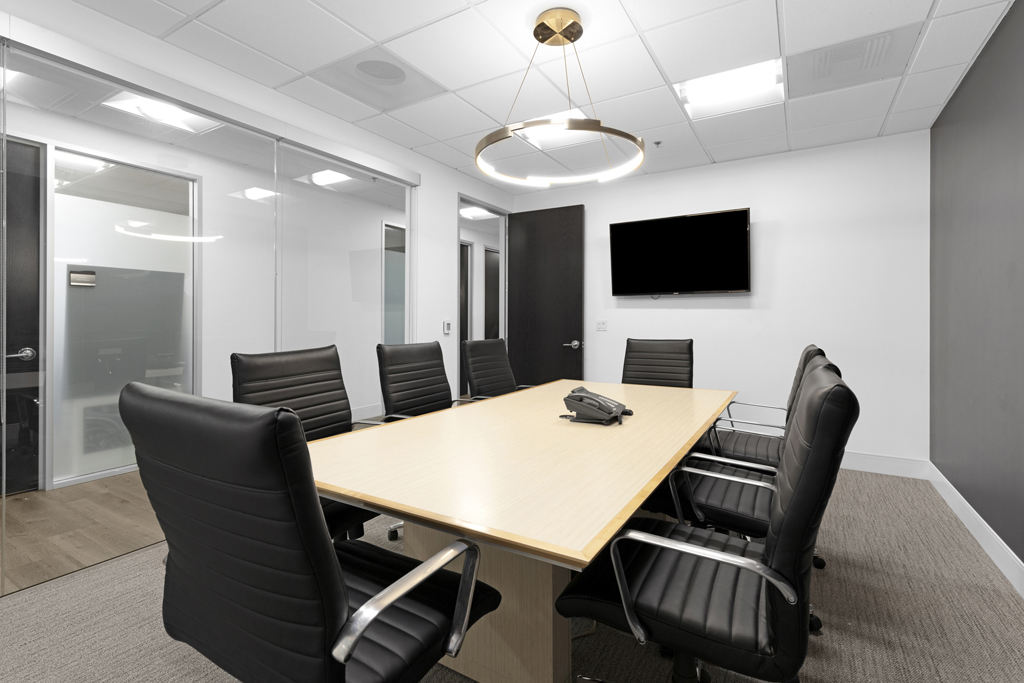 Large meeting room with modern seating and display
