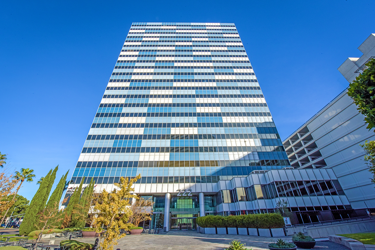 Modern glass skyscraper against blue sky