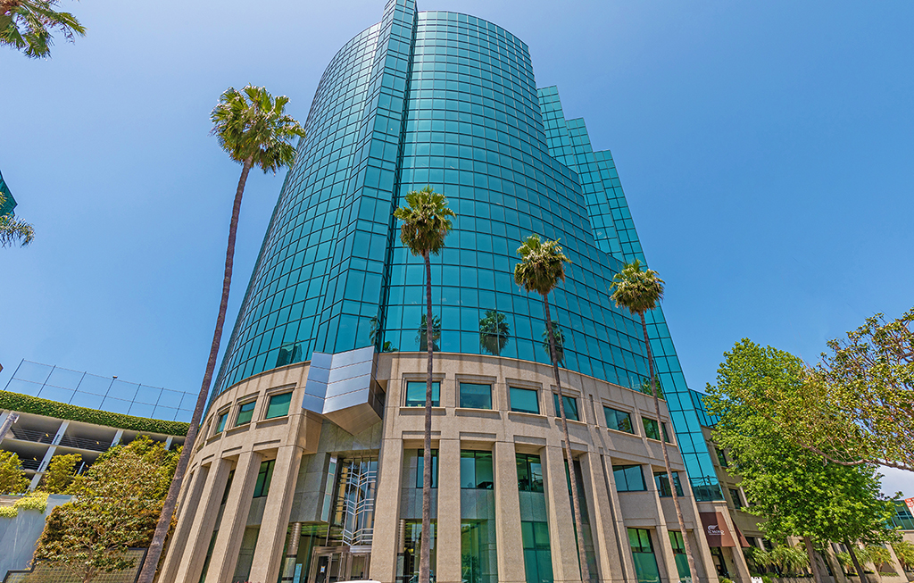 Modern glass building with palm trees