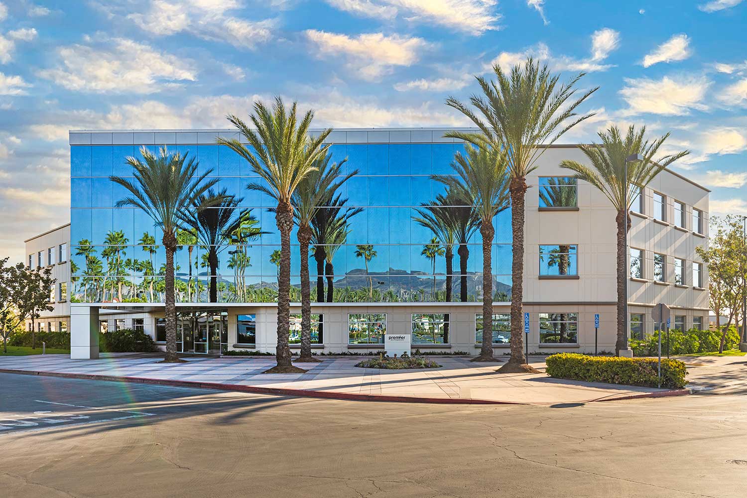 Modern building with palm trees reflection