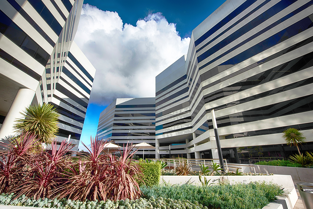 Modern buildings with lush landscaping.