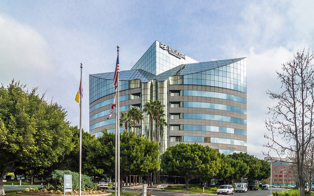 Modern glass office building with flags