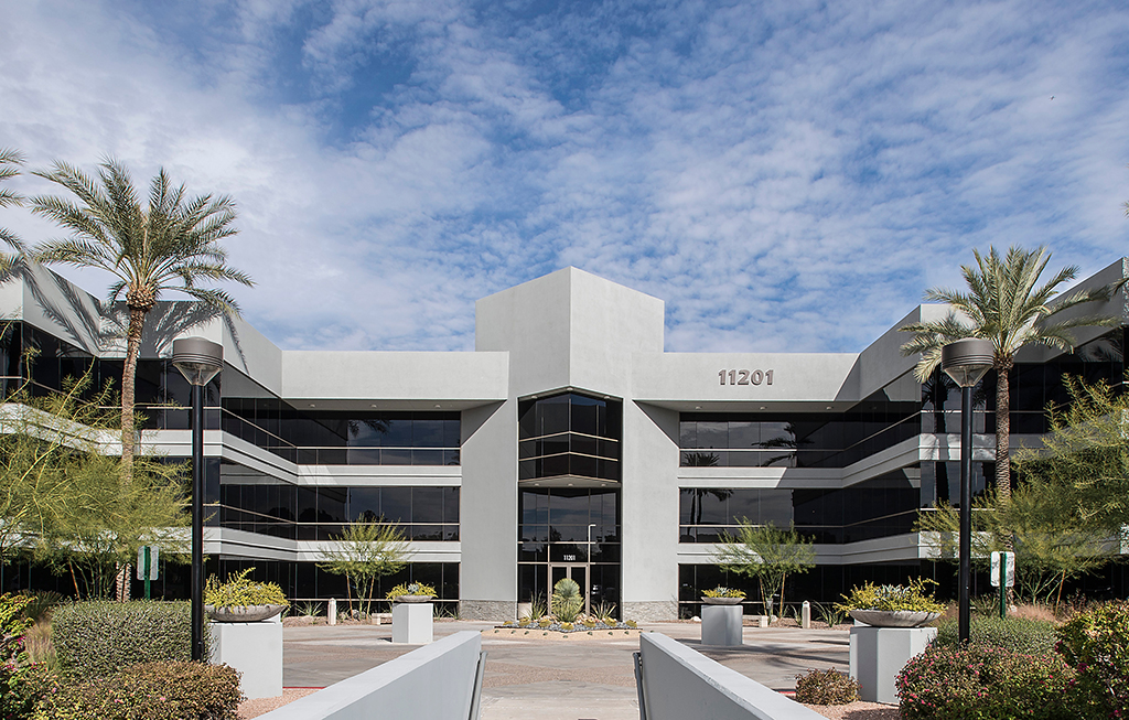 Modern office building with palm trees