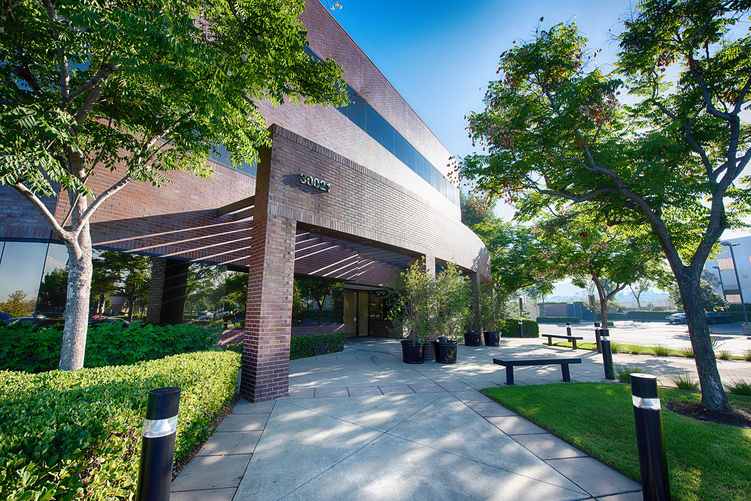 Building entrance side view with trees and blue sky