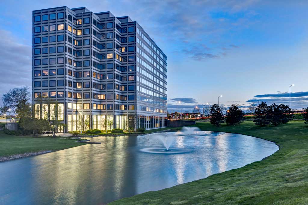 Modern office building by serene pond