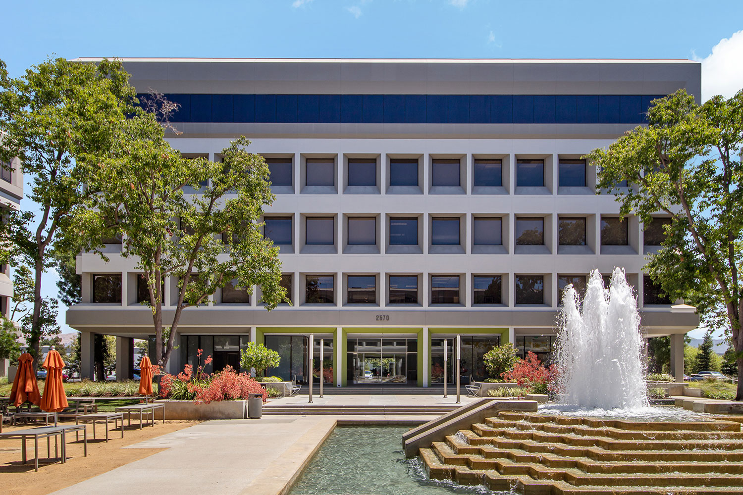 Modern building with fountain and trees