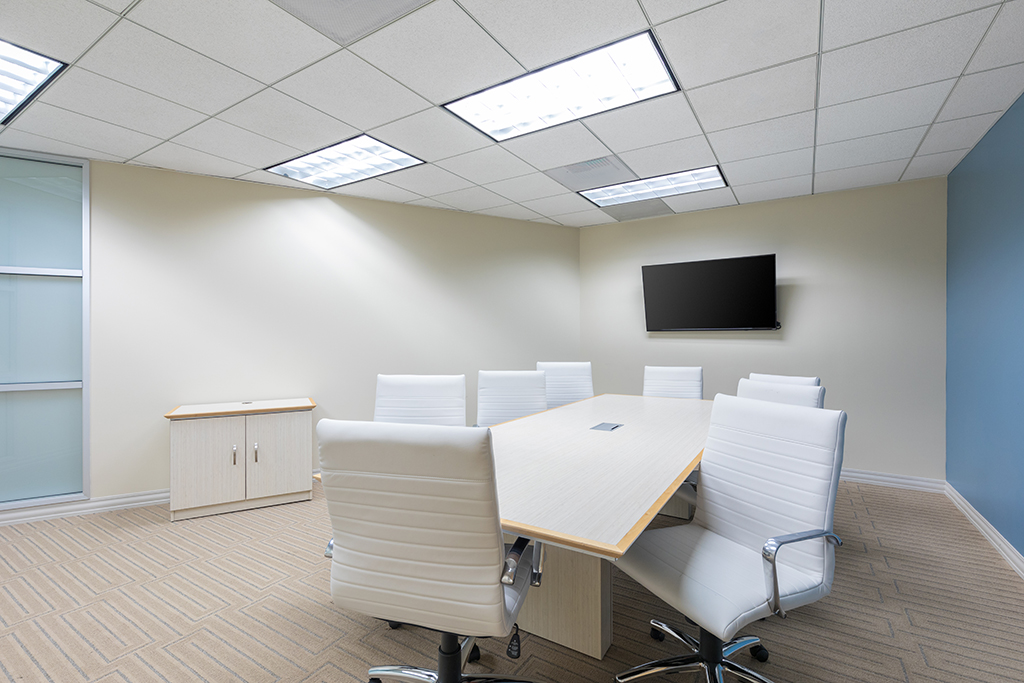 Modern conference room with 8 white chairs
