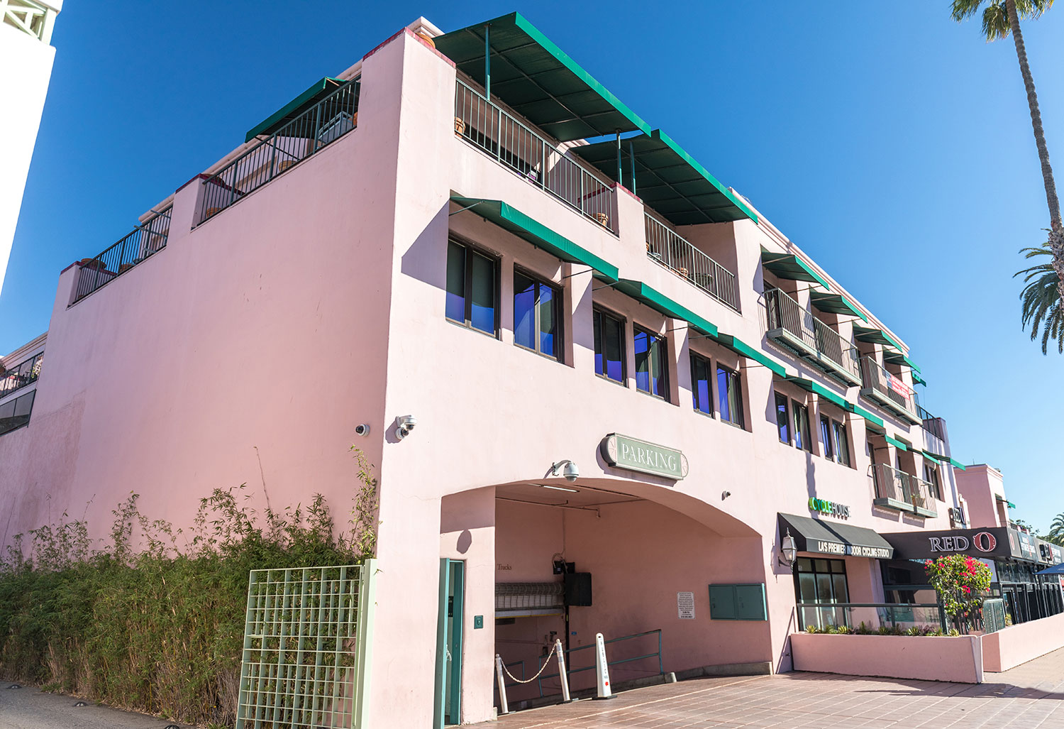 Pink building with green awnings
