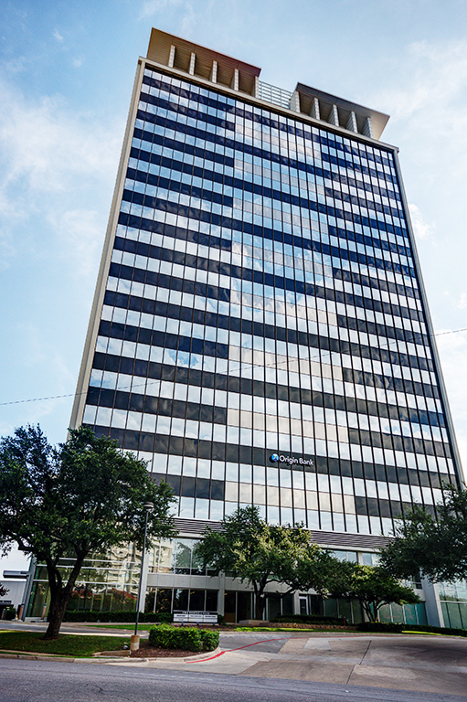 Modern glass office building with trees