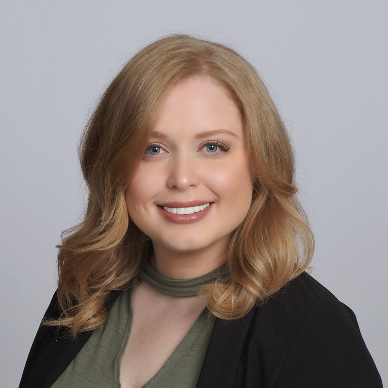 Woman with blonde hair and green top