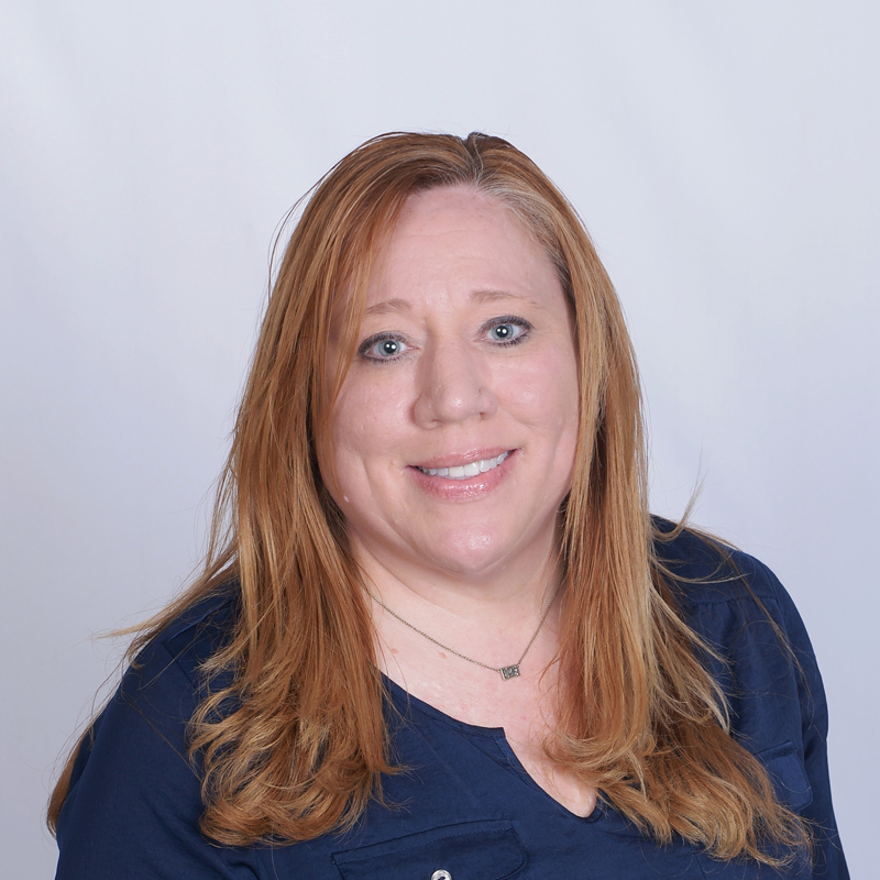 Long-haired woman in casual attire.