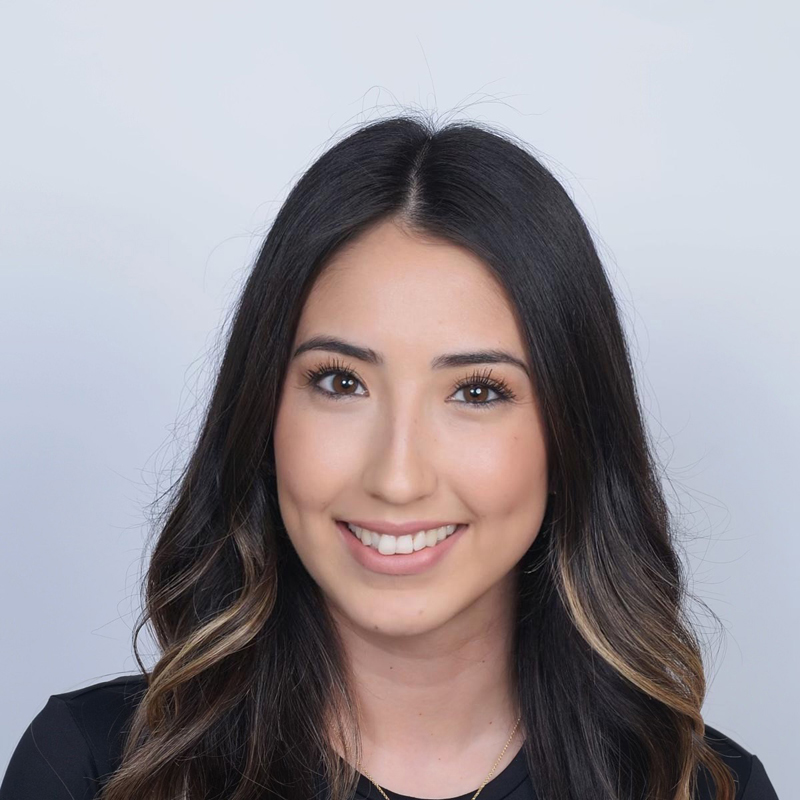 Long wavy hair, neutral background.