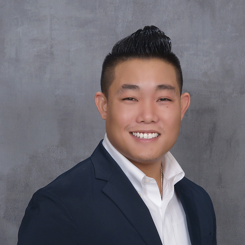Man in formal attire, serious expression.