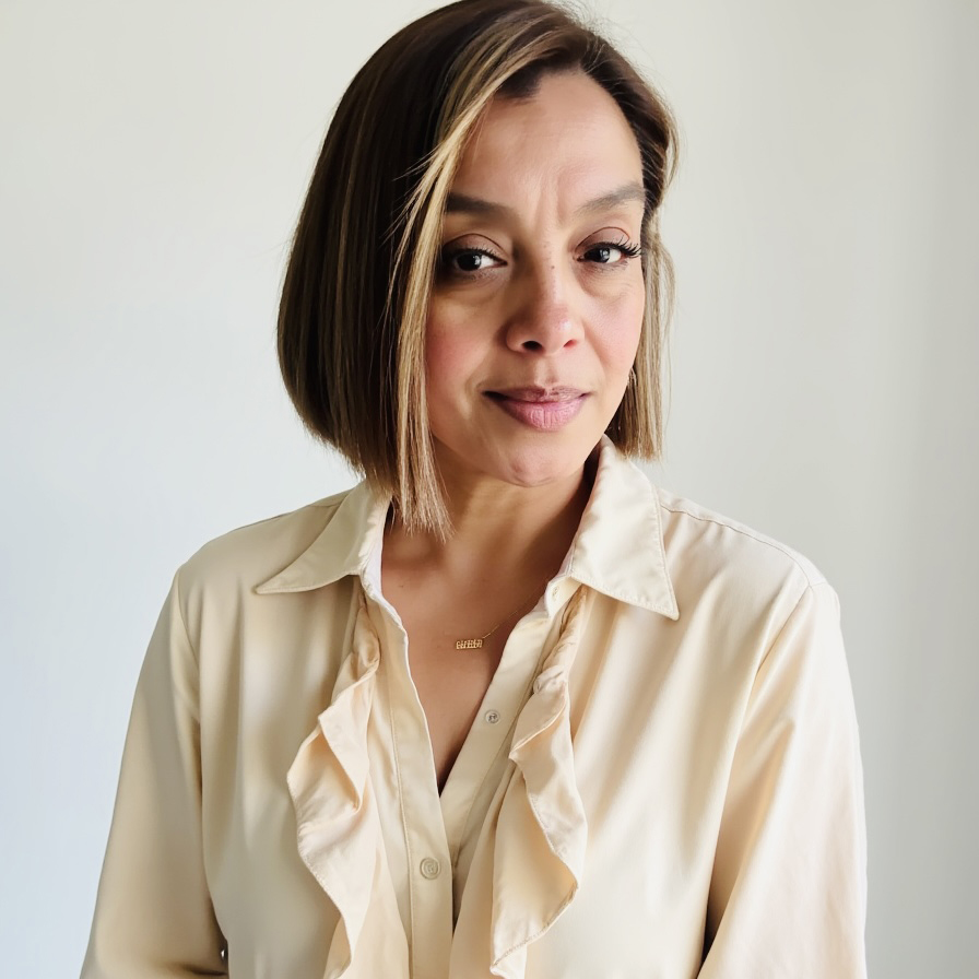 Woman in professional attire with short hair